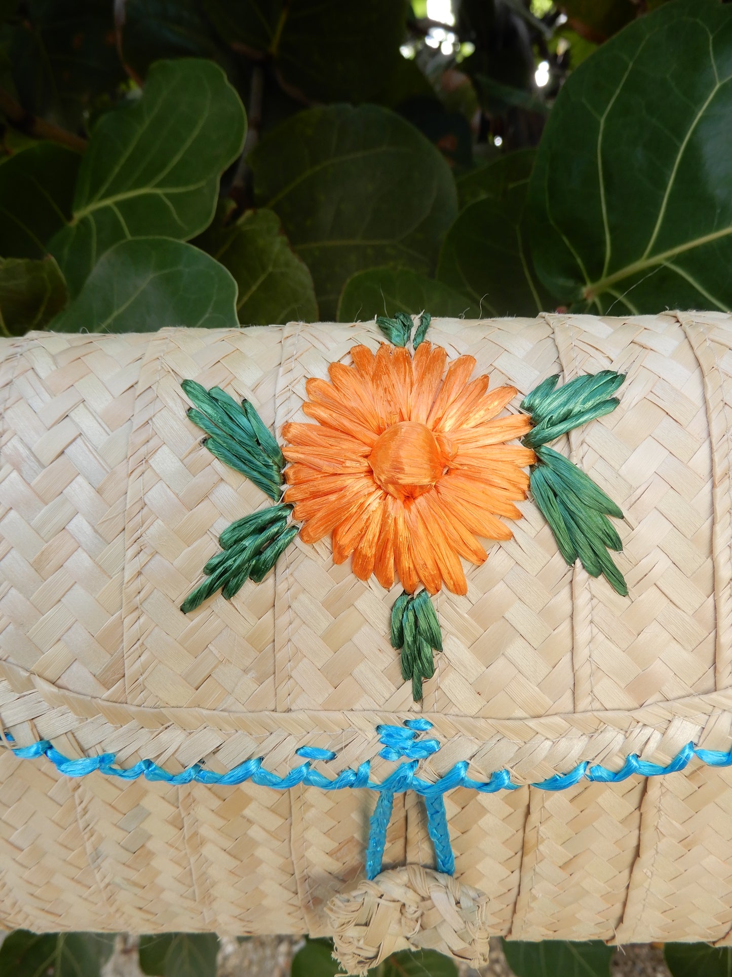 Thatch Clutch with orange flower + blue straw piping