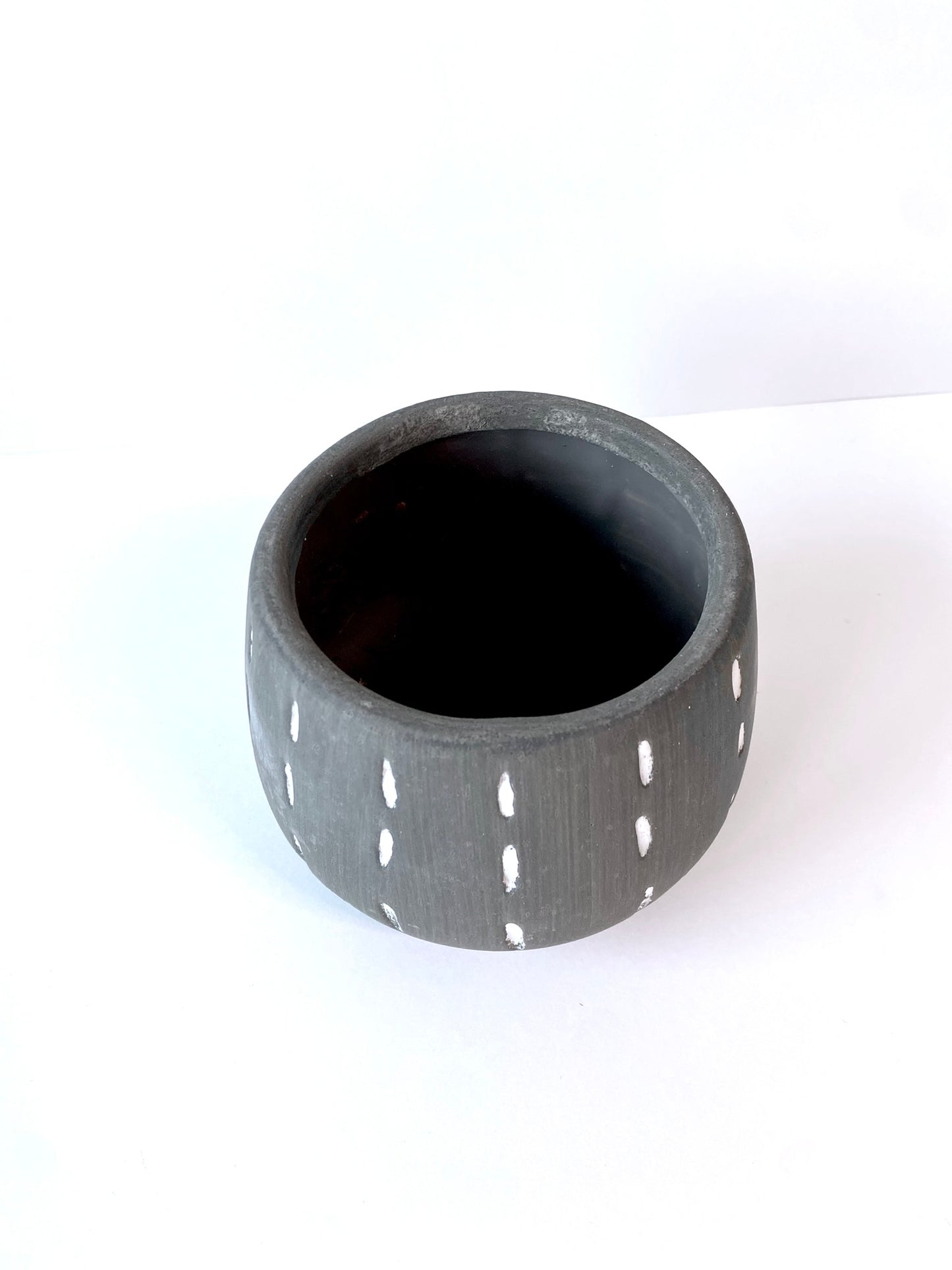 grey planter with hand-painted lines