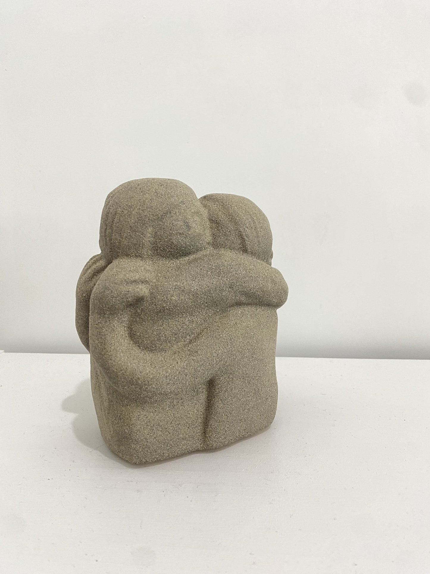 hugging figures figurine